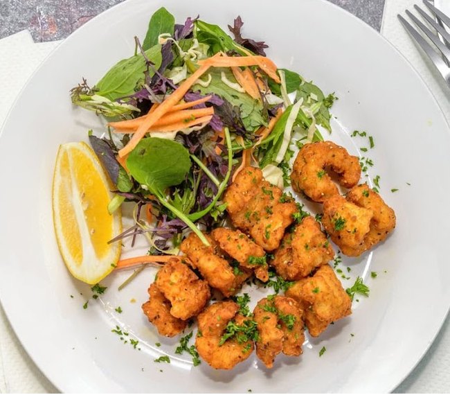 Freshly fried calamari with a garden salad at Tipene's Takeaway