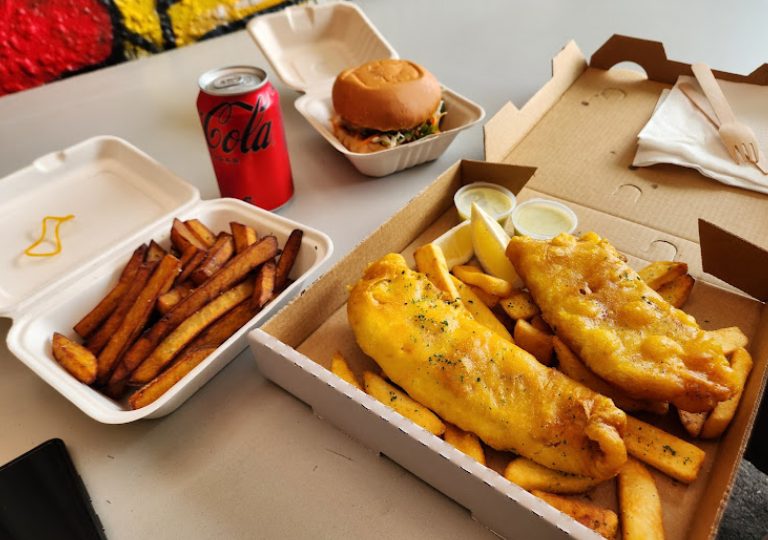 The full feed — fish, chips, burger and a drink